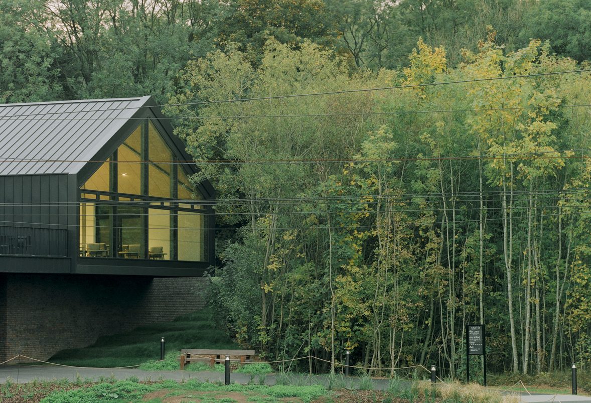 One of the three zinc columes of the visitor centre cantilevering into the surrounding woodland landscape.
