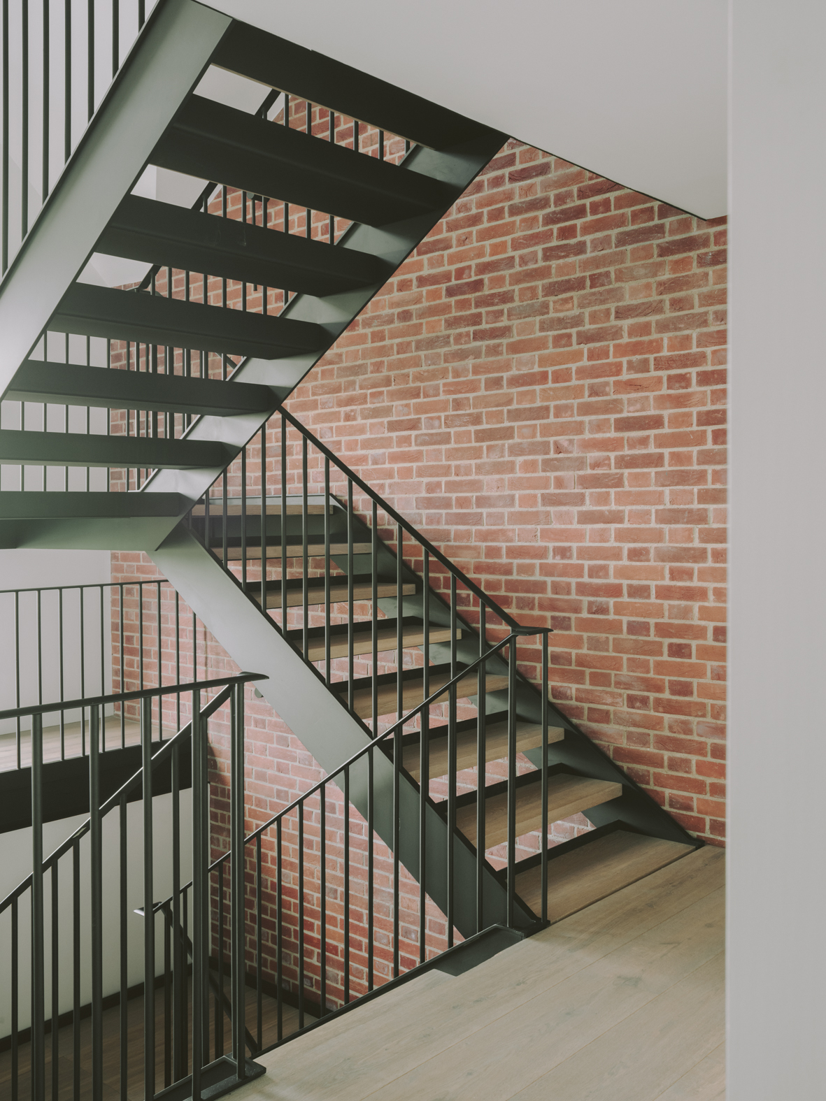 Steel internal staircase with steel balustrade and handrail at Chelwood house.