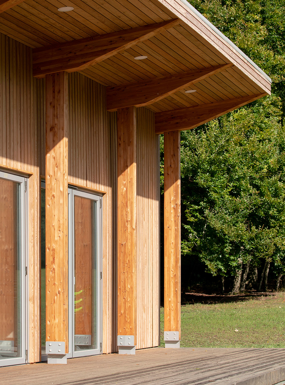 The glulam timber colonnade facing onto the playing views, sheltered by the cantilevered roof.