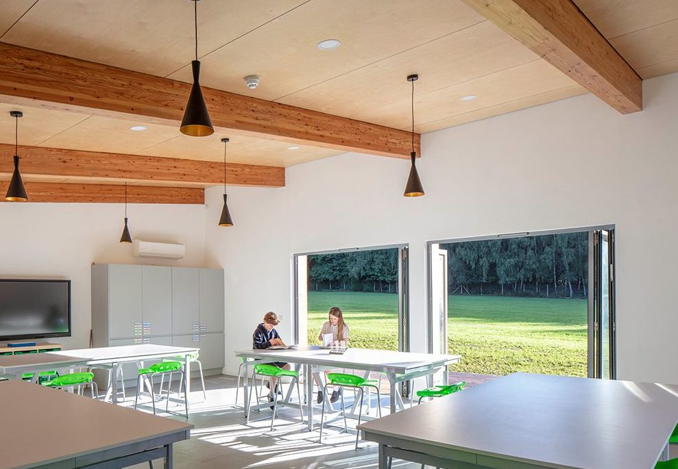 The science classroom has a simple palette of timber, plywood and white walls inside, creating a light and airy feel.