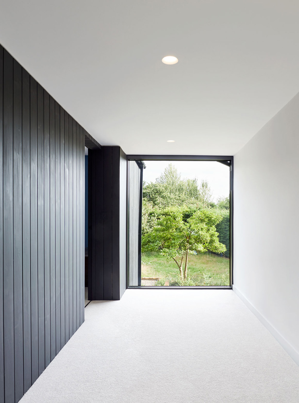 View along the first floor corridor with internal black timber cladding at Samarkand.